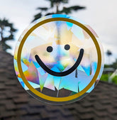 Happy smiling face yellow and black rainbow suncatcher decal on a window